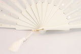 Handmade fan adorned with hand sewn sequins on a cream painted Danta wood frame close up