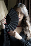 Model holding Black Paris fan with hand sewn sequins